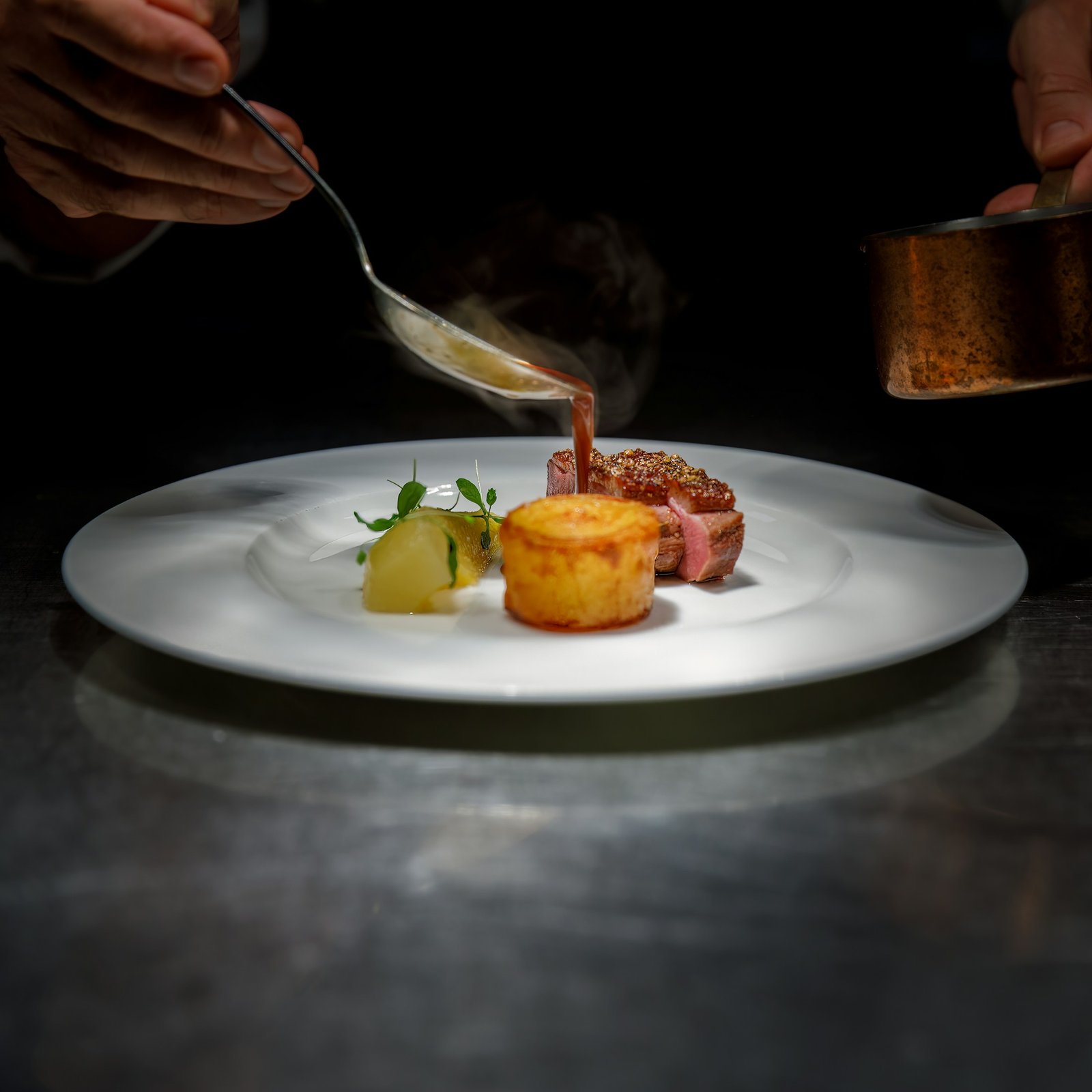 Chef finishing a beautifully plated dish